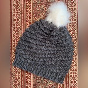 Hat: Charcoal gray with spiral design. White removable faux fur Pom Pom
